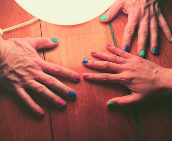 High angle view of hands on table