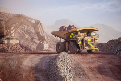 View of vehicles on road against mountain range