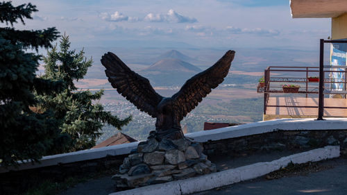 Close-up of eagle sculpture against sky