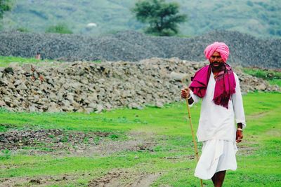 Full length of man in traditional clothes standing on field