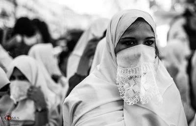 Portrait of woman wearing mask outdoors