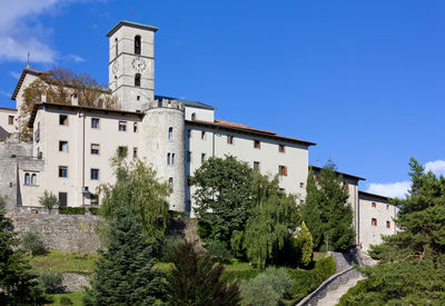 Low angle view of old building against clear blue sky