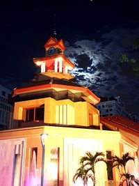 Low angle view of bell tower against sky at night