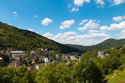 Scenic view of houses and mountains against sky