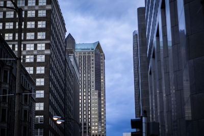 Low angle view of modern buildings against sky in city