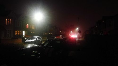 Cars in illuminated city at night