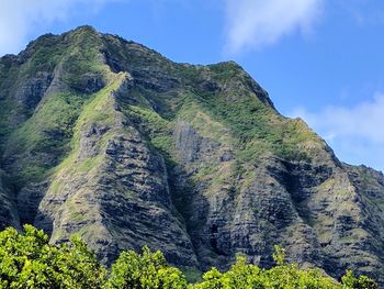 Low angle view of mountain against blue sky