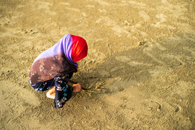 High angle view of boy playing on beach