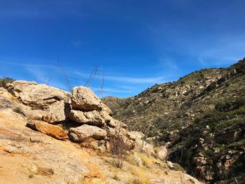 Scenic view of mountains against blue sky