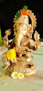 Close-up of buddha statue on table