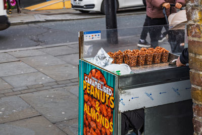 Roasted chestnut stall on sidewalk in camden town street scene. london, uk, 26 december 2023
