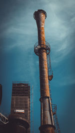 Low angle view of smoke stack against sky