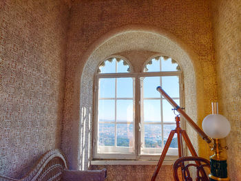 Day photography of astronomy room with telescope facing window at palacio da pena, sintra, portugal