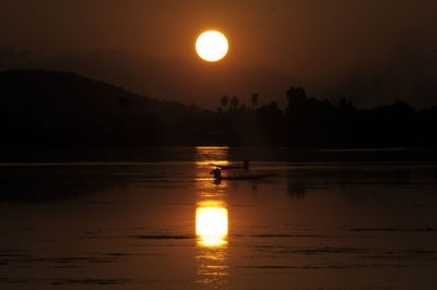 Scenic view of lake against sky during sunset