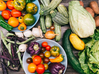 High angle view of tomatoes and fruits on vegetables