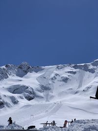 Snowcapped mountains against clear blue sky