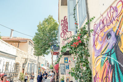 Panoramic shot of graffiti on street amidst buildings in city