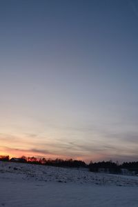 Scenic view of snow against sky during sunset