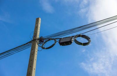 Low angle view of electricity pylon against sky