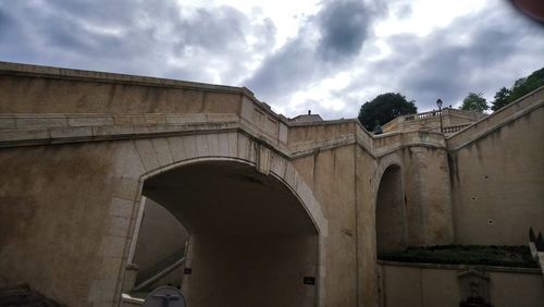 Low angle view of arch bridge against sky