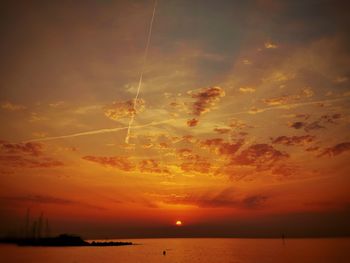 Scenic view of sea against romantic sky at sunset