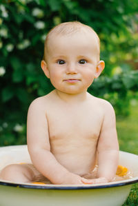 Portrait of cute baby boy in park