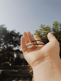 Person holding necklace in the nature