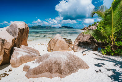 Panoramic shot of rocks on beach against sky