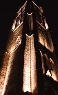 Low angle view of illuminated building against sky at night