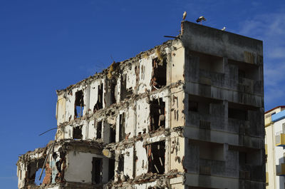 Low angle view of abandoned building against sky