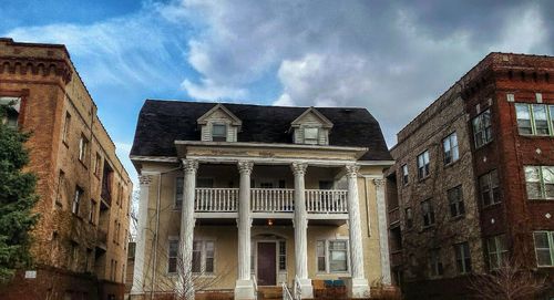 Low angle view of building against cloudy sky