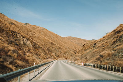 Road amidst mountains against sky