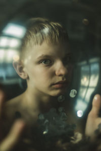 Portrait of boy through the glass