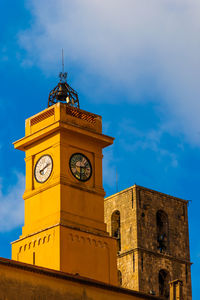 Low angle view of clock tower against sky