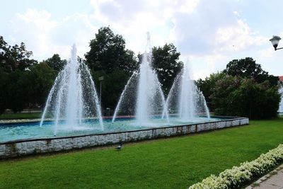 Fountain in park against sky