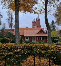 Countryside or village landscape with house and church in autumn