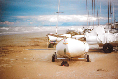 Airplane on beach against sky