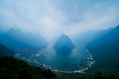 High angle view of lake amidst mountains against sky