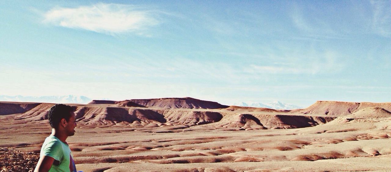 lifestyles, leisure activity, sky, men, rock - object, rock formation, travel, casual clothing, full length, standing, tourist, vacations, landscape, nature, rear view, scenics, person, mountain