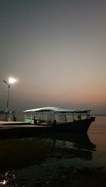 Boats moored on sea against clear sky