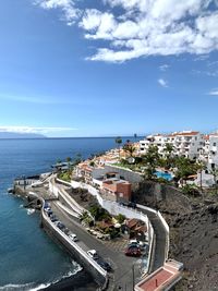 High angle view of buildings by sea against sky