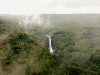 Scenic view of waterfall against sky