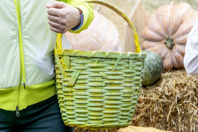 Midsection of person holding ice cream in basket