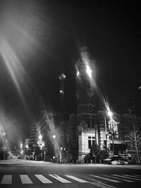 Low angle view of illuminated buildings against sky at night