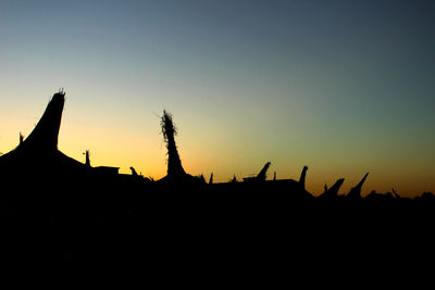 Silhouette plants against clear sky during sunset