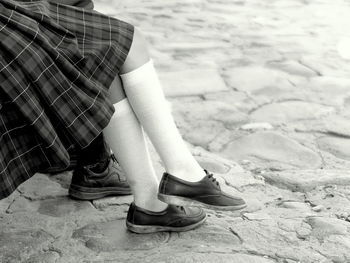 Low section of girls sitting over street