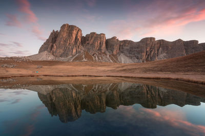 Reflection of mountains in lake at sunset