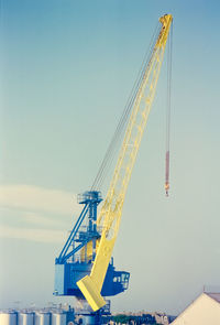 Low angle view of crane against clear sky