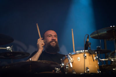 Man with arms raised in music concert