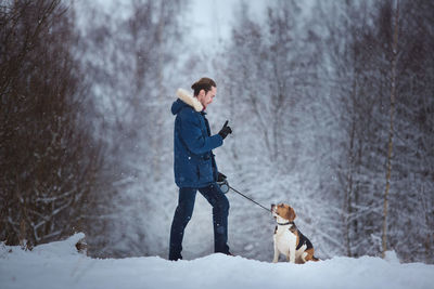 Dog standing on snow covered landscape